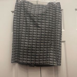 Above the knee skirt with split in the back.